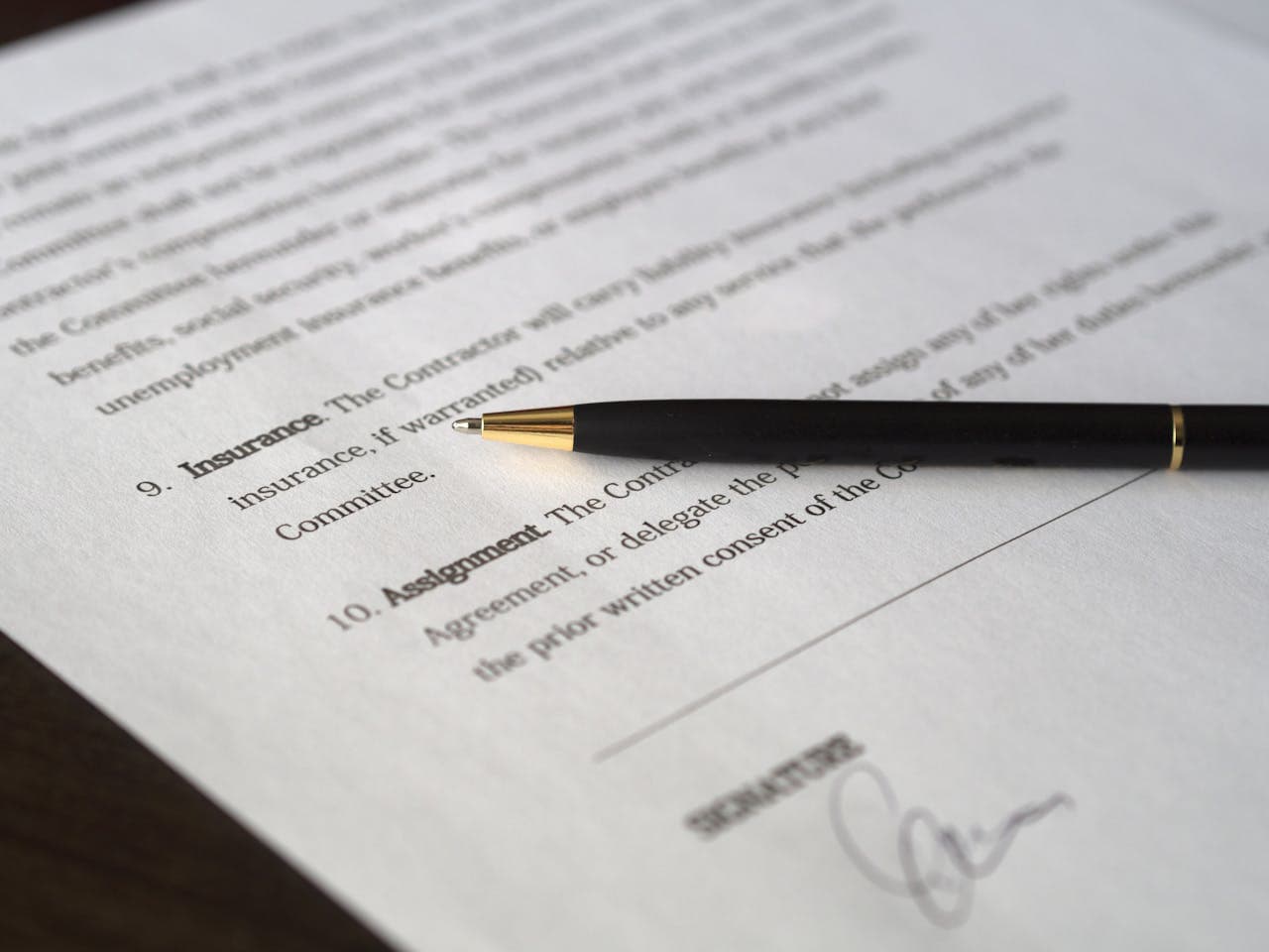 about-us-02 Close-up image of a business contract and pen, signed and ready for agreement.