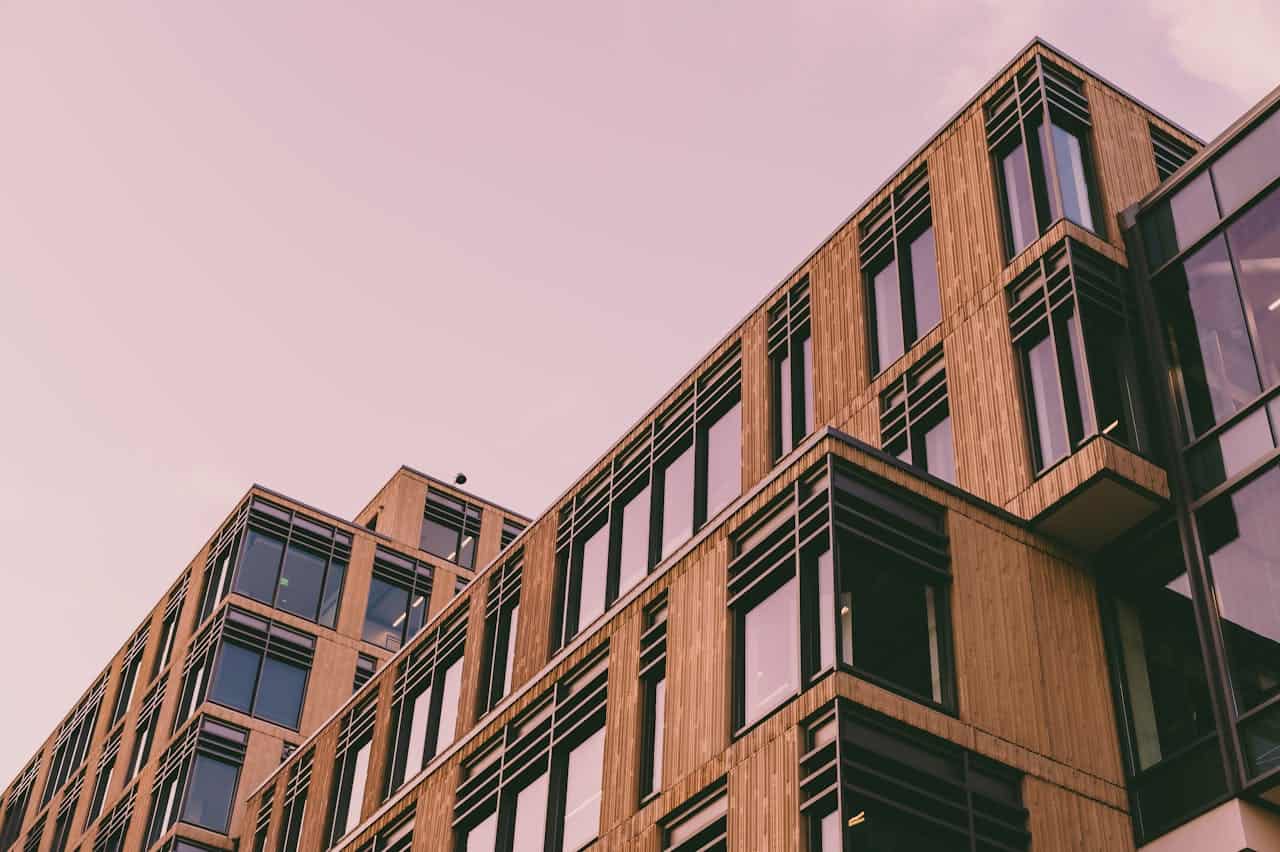 heros-img From below of modern geometric building with windows and balconies located against cloudless sky